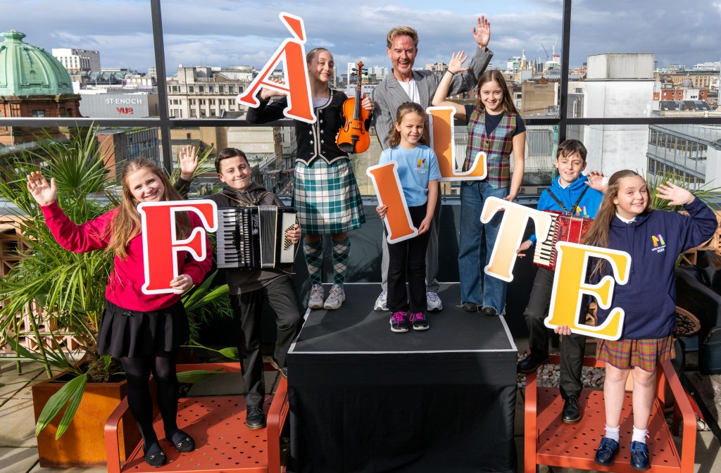 Phil MacHugh with young musicians at Mòd launch event